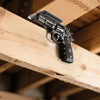 A black magnetic gun mount with a quick-release lock is shown mounted on a wooden beam.