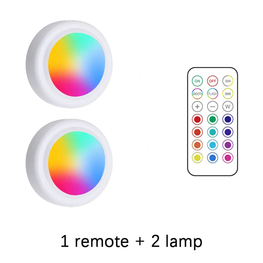 Two round RGB LED lamps and a remote control for lighting.