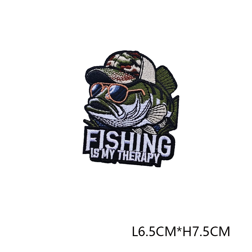 A black and green embroidered fishing patch featuring a fish wearing sunglasses with the text FISHING IS MY THERAPY