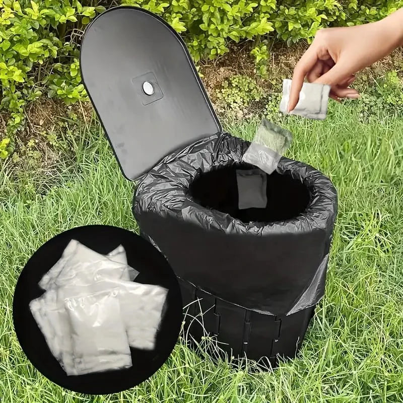A black portable toilet with absorbent powder packets is shown in a grassy outdoor setting.