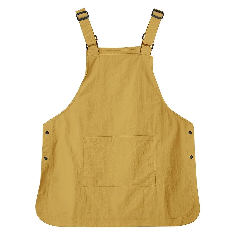 A mustard yellow waterproof unisex work apron with chest pockets and adjustable straps.