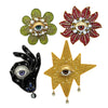 Three decorative patches featuring stylized eyes made of green, red, and gold rhinestones and beads.