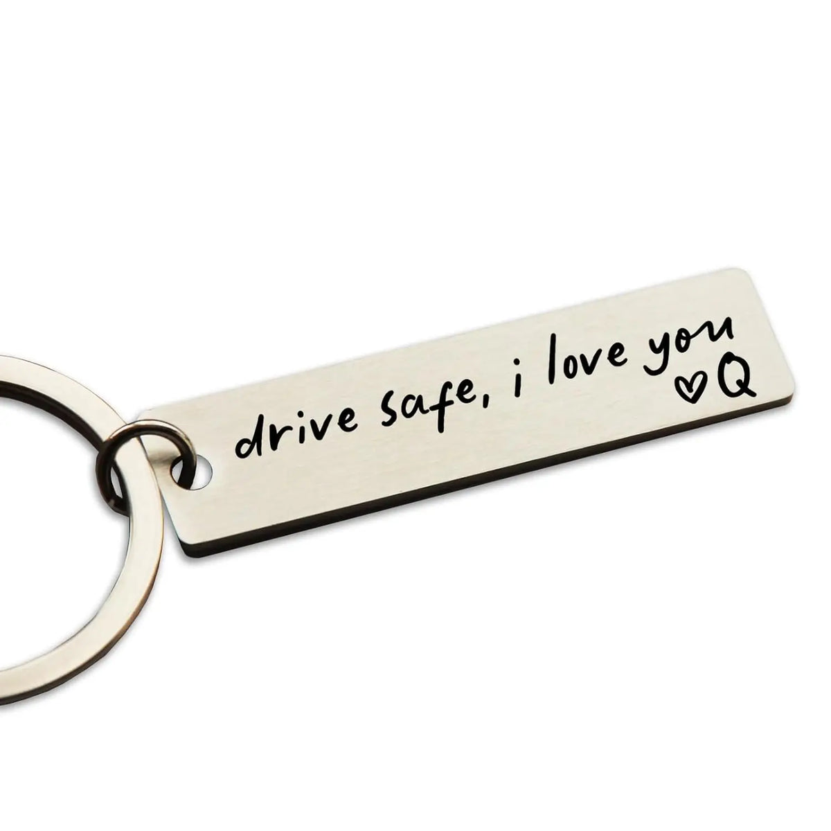 A personalized stainless steel keychain tag engraved with the message drive safe i love you and a heart symbol.