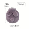 A round, purple plush rabbit hot water bottle with soft flannel ears and a clear lid.