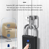A hand is pressing a fingerprint onto a smart security fingerprint recognition padlock installed on a white door panel.