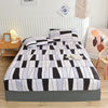 A fitted bed sheet featuring a black and white marbled print with an all-around elastic band.