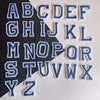A set of embroidered alphabet patches featuring uppercase letters from A to Z in blue and white thread.