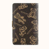 A black leather notebook featuring a gold-toned cartoon bear design for lockable money organization.