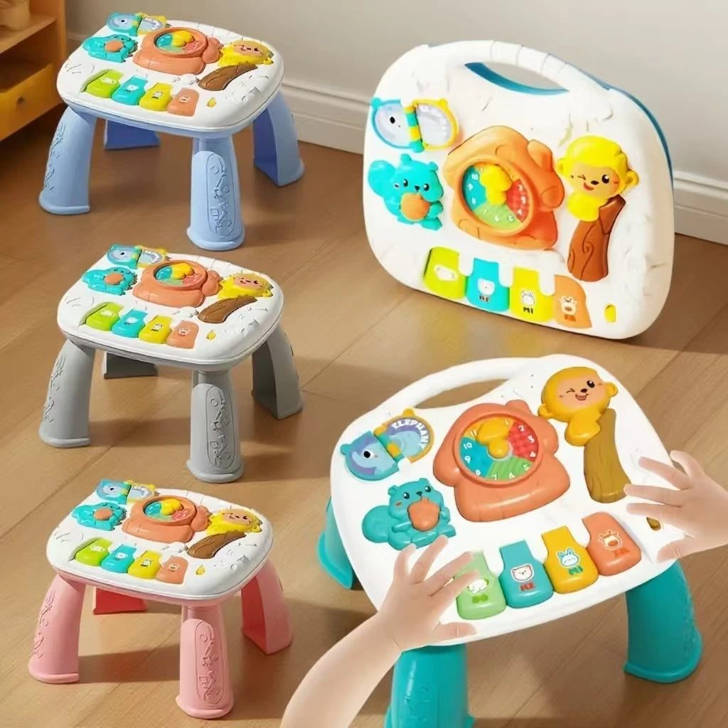 A child's hand is interacting with a white baby activity table featuring colorful toys like a piano and steering wheel.