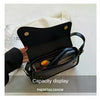 A black vintage leather crossbody bag with a flap closure is displayed against a white background.