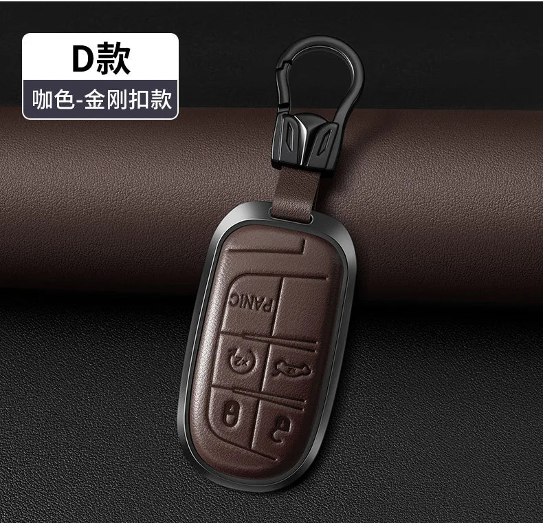 A dark brown leather and metal key fob with a split ring attached, shown against a dark background.