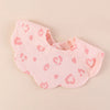 A pink soft cotton baby bib in a bandana style with a leopard print pattern