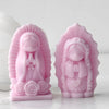 Pink silicone mold of a praying girl figure used for candles, soap, and craft decor