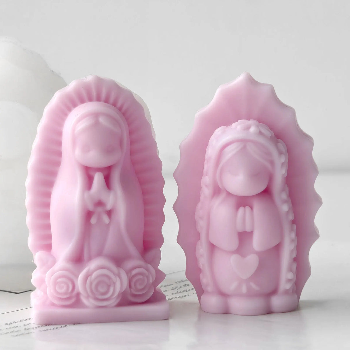 Pink silicone mold of a praying girl figure used for candles, soap, and craft decor