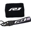 Black neoprene sock with a white R1 logo and a black strap for a brake fluid reservoir cover.
