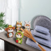 A set of adorable animal needle felting mats in various colors resting on a wooden surface.