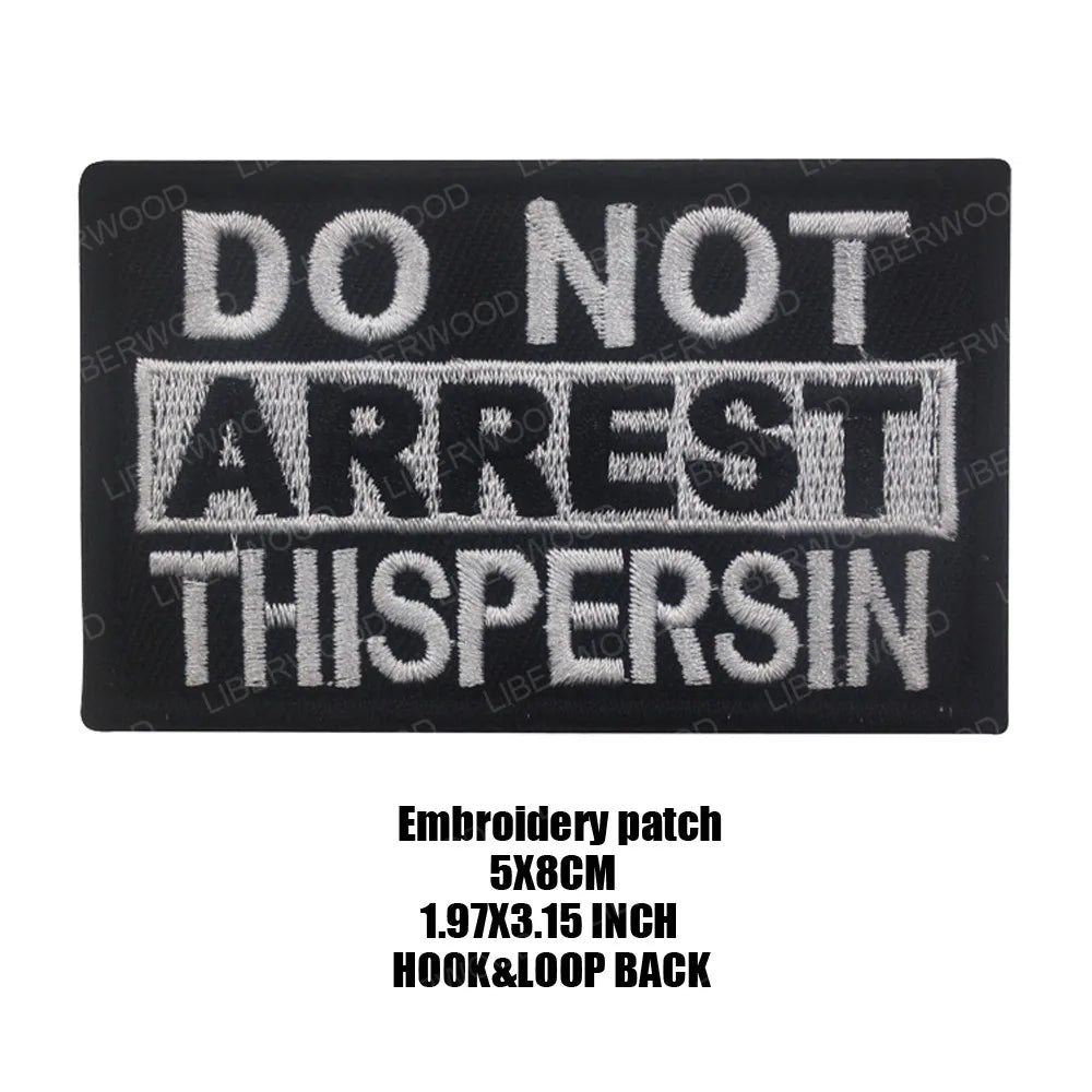 Black embroidered patch with white text that reads DO NOT ARREST THISPERSON