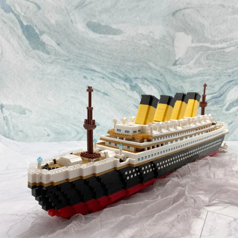 A detailed LEGO model kit of the Titanic ship featuring black, yellow, and white colors against a marbled background.