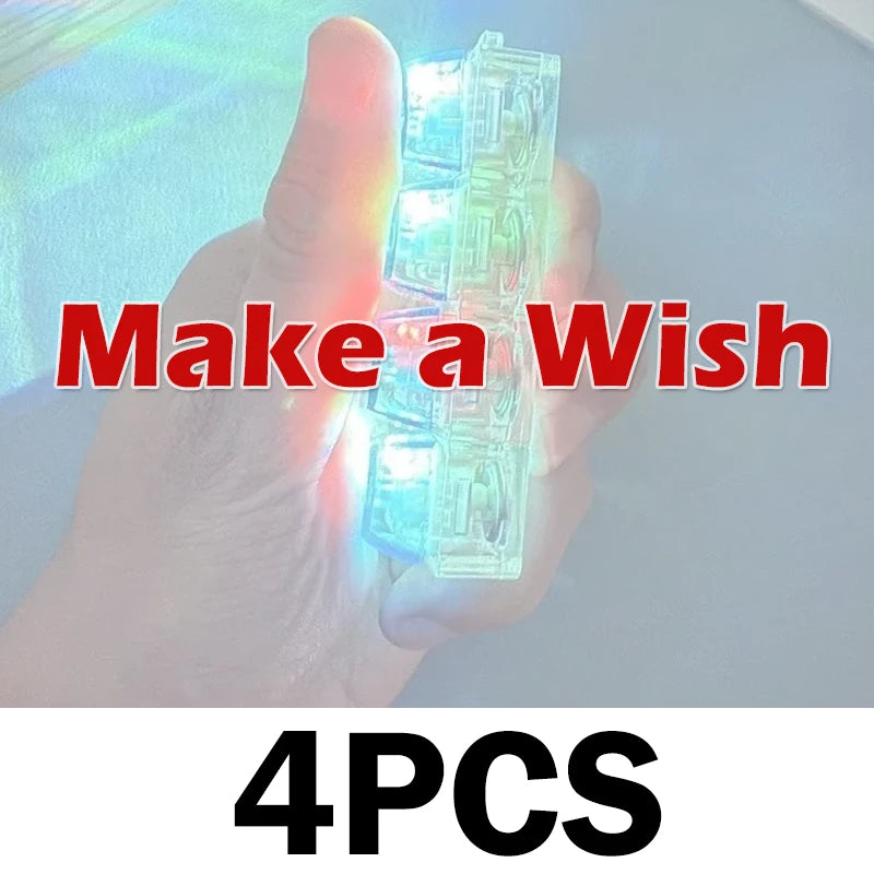 A hand holds a clear, light-up keyboard keychain fidget toy with four pieces.