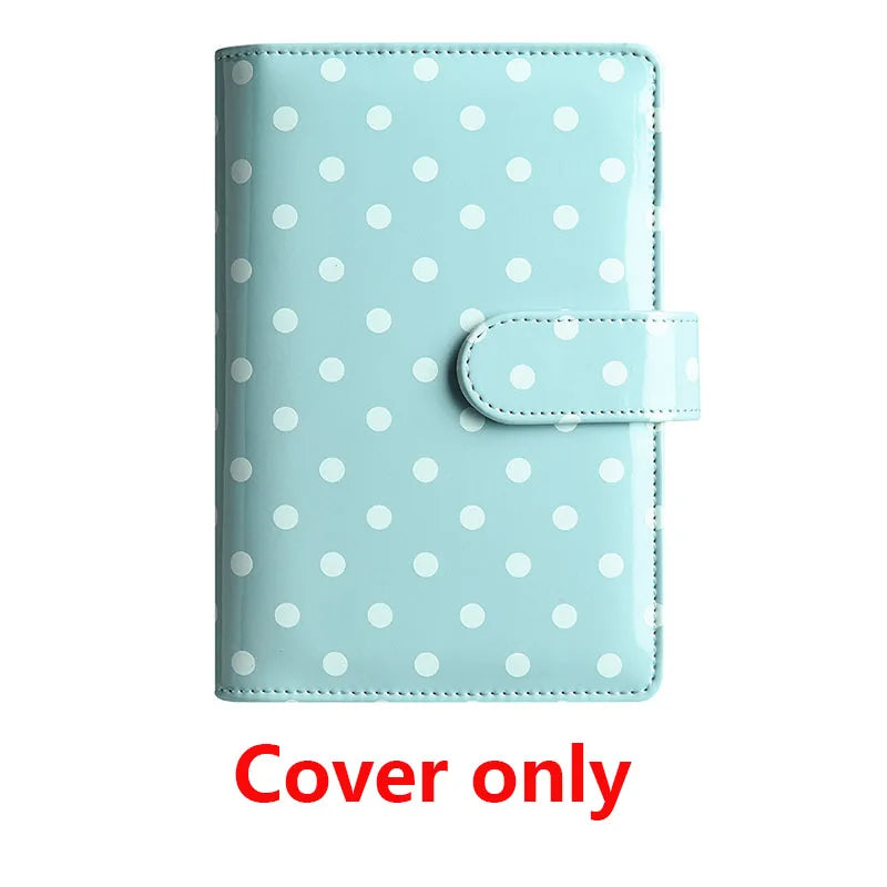 Light blue polka dot PU leather binder wallet with a clear plastic cover and a flap.