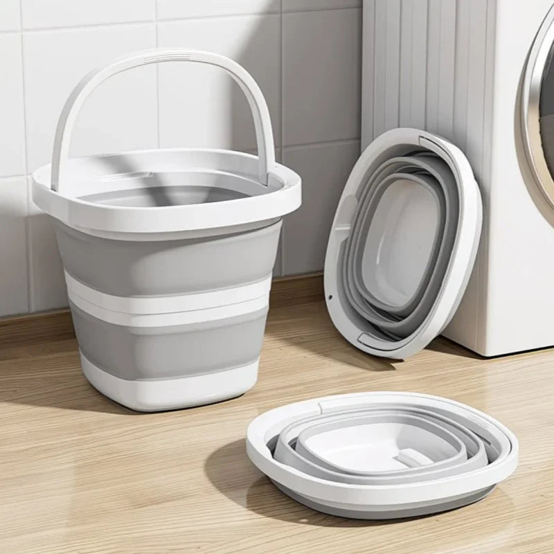 A white collapsible bucket and a white portable toilet are shown on a wooden floor.