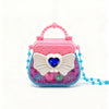 A pink and purple makeup toy set featuring a heart-shaped cosmetic case with iridescent accents and blue beads.