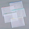 A set of ten white mesh zipper bags for classroom and craft organization