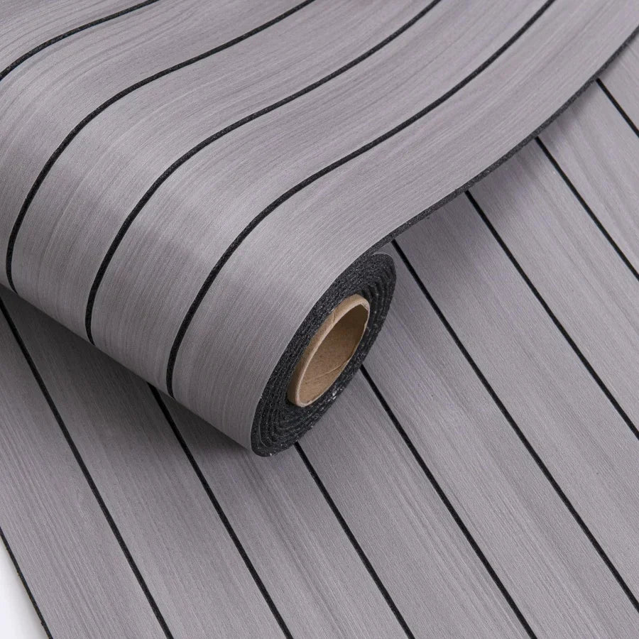Roll of gray 3D grille pattern peel-and-stick wallpaper showing vertical lines.