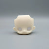 A light beige articulated BJD collectible figurine with a smooth, rounded head and visible eye sockets.