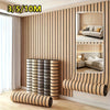 Rolls of self-adhesive wood grain wallpaper featuring vertical stripes in beige and gray tones on a wall.