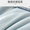 Close-up of a light blue, textured fabric blanket being draped or folded.