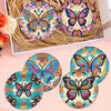 A set of eight ocean-themed diamond art coasters featuring colorful butterfly designs displayed in a natural fiber holder.