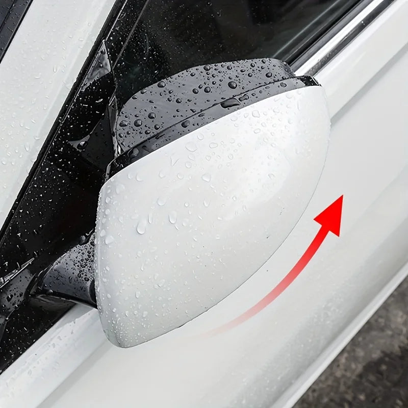 A close-up of a white car blind spot mirror with a clear rain shield, showing water droplets on the surface.