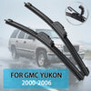 A pair of black windshield wiper blades for a GMC Yukon, shown against a blurred background.