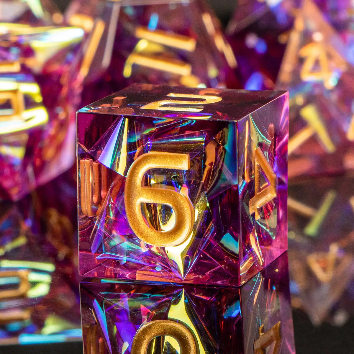 A close-up of a translucent purple resin polyhedral die with gold numbering, set against other similar dice.