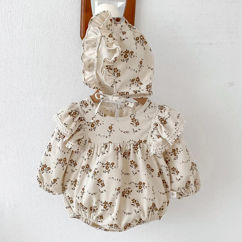 A beige floral lace cotton romper for a baby girl with ruffled details.