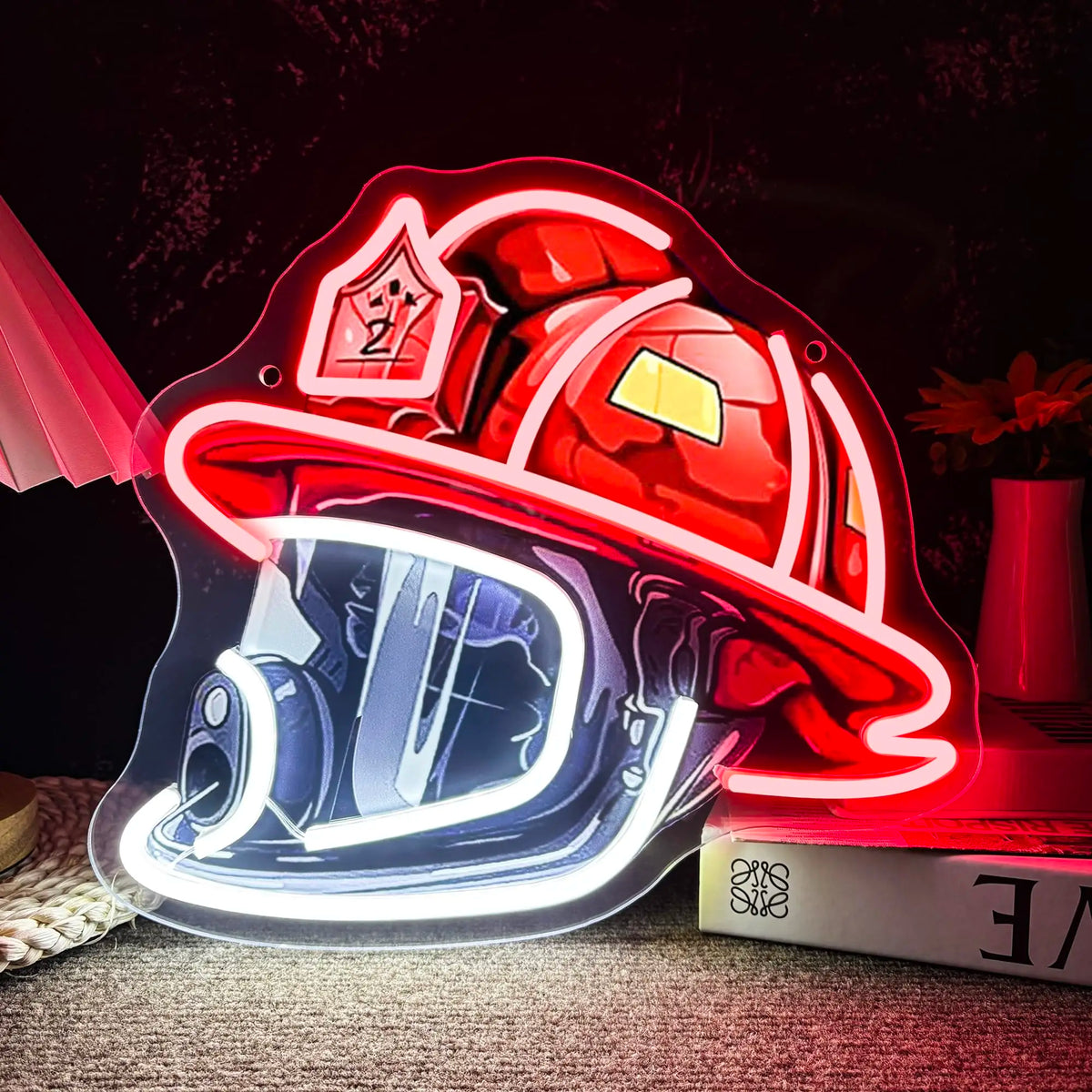 A red firefighter helmet neon sign with a clear visor and emblem, illuminated against a dark background.