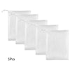 Five white exfoliating soap net bags stacked in a row