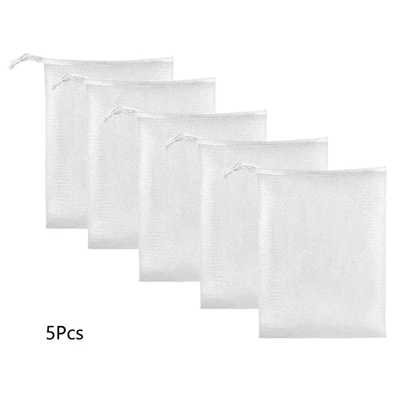 Five white exfoliating soap net bags stacked in a row