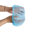 A hand wearing a light blue disposable hair net cap for microblading and permanent makeup.