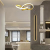 A modern interior features a gold LED pendant light fixture above a counter area.