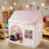 A pink floral playhouse tent for kids with a dome roof and arched entrance, set in a brightly decorated room.
