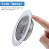 A hand is holding a round, silver sink drain strainer with a double-layer design.