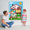 A man points to a colorful felt board depicting a farm scene with animals and houses, near a young girl.