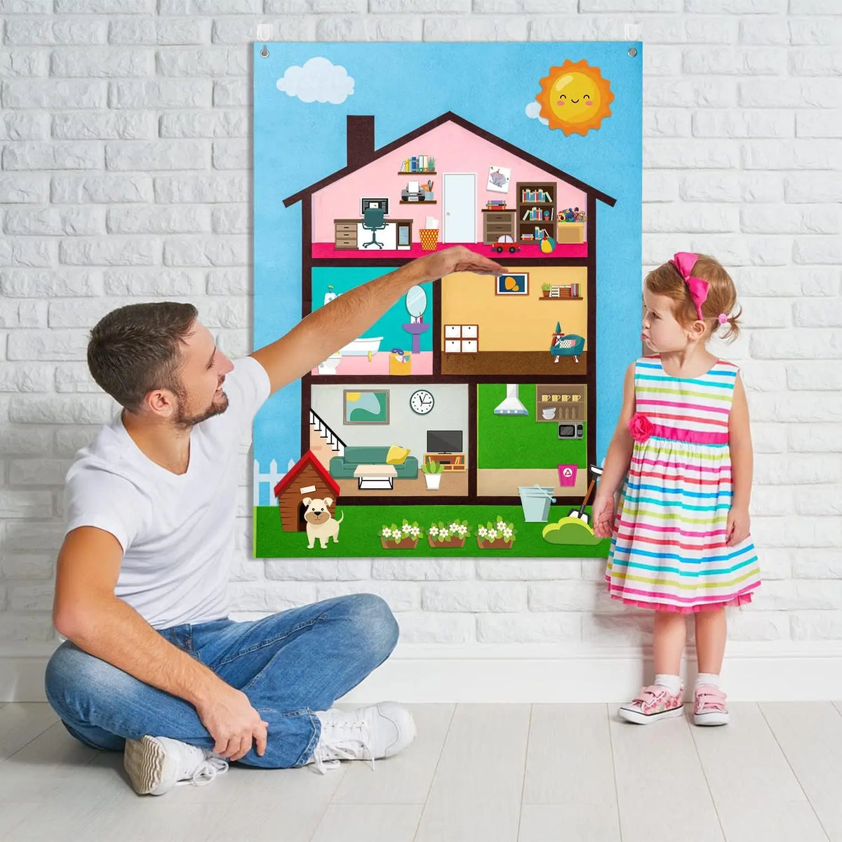 A man points to a colorful felt board depicting a farm scene with animals and houses, near a young girl.