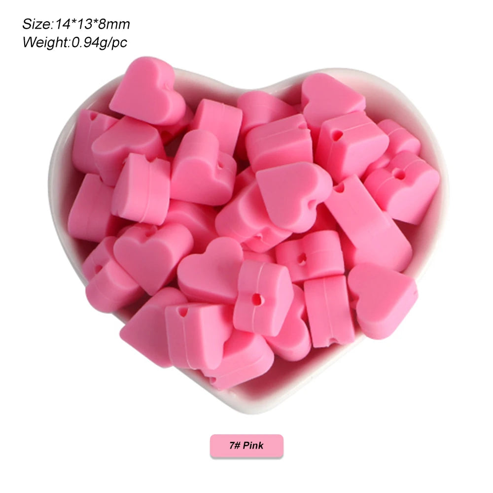 A pile of pink silicone heart and star beads for DIY jewelry making