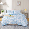A light blue heart print duvet cover set with white hearts and pillowcases on a bed.