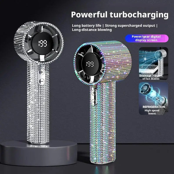 A silver and iridescent diamond-encrusted handheld fan with a digital display is shown against a dark background.