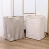 Two foldable waterproof laundry baskets, one striped gray and the other beige, standing on a wooden floor.