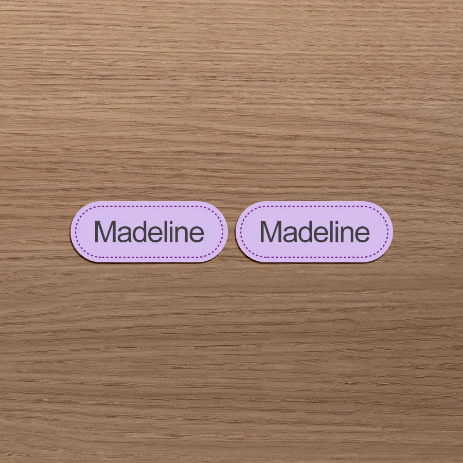 Dos etiquetas ovaladas rosas con el nombre Madeline impreso
